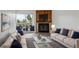 Inviting living room with fireplace, plush sofas, and access to a private balcony at 14700 E Kentucky Dr # 524, Aurora, CO 80012