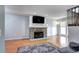 Living room with stone fireplace and hardwood floors at 1370 S Idalia St # C, Aurora, CO 80017