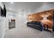 Finished basement recreation room with sofa, wood wall, and wet bar at 3131 S Leyden St, Denver, CO 80222