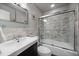 Bathroom features a bathtub and shower combo, marble tile, and a floating vanity at 3131 S Leyden St, Denver, CO 80222