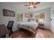 Bedroom with a full-size bed, hardwood floors, and built-in shelving at 3131 S Leyden St, Denver, CO 80222