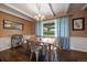 Bright dining room features hardwood floors, a wooden table with metal chairs, and a view of the backyard at 3131 S Leyden St, Denver, CO 80222