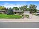 Ranch home with a large front yard and driveway at 3131 S Leyden St, Denver, CO 80222