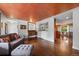 Open living room with hardwood floors and view to dining area at 3131 S Leyden St, Denver, CO 80222