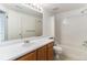 Bathroom featuring a shower-tub combination with white tile surround and vanity at 7453 Singing Hills Dr, Boulder, CO 80301