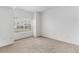 Bright, carpeted bedroom with a large window offering natural light and a view at 7453 Singing Hills Dr, Boulder, CO 80301