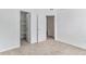 Carpeted bedroom showcasing closet, bathroom, and access to other rooms at 7453 Singing Hills Dr, Boulder, CO 80301