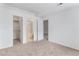 Neutral bedroom with carpet, showing closet, bathroom, and access to other rooms at 7453 Singing Hills Dr, Boulder, CO 80301