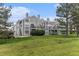 Well-maintained condo building featuring balconies, lush lawn, and mature trees at 7453 Singing Hills Dr, Boulder, CO 80301
