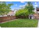 Green backyard with a wooden fence, a small playhouse, and a lush lawn at 10535 Laurelglen Cir, Highlands Ranch, CO 80130