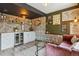 Finished basement with a bar, built-in beverage cooler, and a comfortable seating area at 10535 Laurelglen Cir, Highlands Ranch, CO 80130