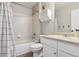 Modest bathroom featuring a shower-tub combo, toilet, and vanity sink with a white finish at 10535 Laurelglen Cir, Highlands Ranch, CO 80130