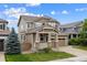 Beautiful two-story home featuring a manicured lawn, covered porch, and a spacious two-car garage for convenient parking at 10535 Laurelglen Cir, Highlands Ranch, CO 80130