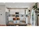 Spacious kitchen featuring white cabinets, stainless steel appliances, a center island with seating, and modern finishes at 10535 Laurelglen Cir, Highlands Ranch, CO 80130