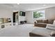 Spacious living room with neutral carpet, gray sectional sofa, play kitchen and ample natural light at 10535 Laurelglen Cir, Highlands Ranch, CO 80130