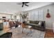 Bright living room featuring hardwood floors, a large sectional, and backyard views at 10535 Laurelglen Cir, Highlands Ranch, CO 80130