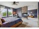 Spacious main bedroom with a cozy fireplace, ample natural light, and a sitting area at 10535 Laurelglen Cir, Highlands Ranch, CO 80130