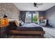 Serene main bedroom featuring a brick wall, comfortable seating, and abundant natural light at 10535 Laurelglen Cir, Highlands Ranch, CO 80130