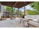 Covered patio with wicker furniture, a cozy rug, and string lights creating a relaxing outdoor space at 10535 Laurelglen Cir, Highlands Ranch, CO 80130
