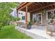 Covered patio with modern wicker furniture, a rug, and access to the green backyard at 10535 Laurelglen Cir, Highlands Ranch, CO 80130