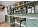 This creative work area boasts custom sage cabinets, a long countertop, and pegboard organizers at 10535 Laurelglen Cir, Highlands Ranch, CO 80130