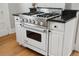 Modern white kitchen with stainless steel appliances and granite countertops at 1825 Albion St, Denver, CO 80220