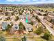 Aerial view of a home nestled in a community surrounded by mature trees and golf course at 9743 Las Colinas Dr, Lone Tree, CO 80124