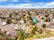 Aerial view of a home nestled in a community surrounded by mature trees and lush landscaping at 9743 Las Colinas Dr, Lone Tree, CO 80124