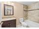 Bathroom features a vanity with granite countertop, updated tile flooring, and shower with stone-like surround at 9743 Las Colinas Dr, Lone Tree, CO 80124