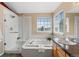 Bright bathroom features a soaking tub, separate shower with glass door, and granite countertops at 9743 Las Colinas Dr, Lone Tree, CO 80124