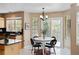 Bright dining area with a modern table, chairs, and sliding glass doors leading to the backyard at 9743 Las Colinas Dr, Lone Tree, CO 80124