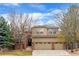 Charming two-story home with a well-manicured lawn and a three-car garage at 9743 Las Colinas Dr, Lone Tree, CO 80124