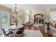 Open-concept kitchen and dining area feature large windows and fireplace, perfect for entertaining at 9743 Las Colinas Dr, Lone Tree, CO 80124