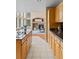Bright kitchen boasts granite counters, wood cabinets, and seamless flow to living area with fireplace at 9743 Las Colinas Dr, Lone Tree, CO 80124