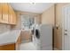 Practical laundry room features modern appliances, ample counter space, and storage cabinets at 9743 Las Colinas Dr, Lone Tree, CO 80124