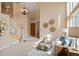 Grand foyer leading to a living area with tall windows, with stylish seating and decor at 9743 Las Colinas Dr, Lone Tree, CO 80124