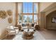 Sunlit living room features soaring windows, stylish decor, and comfortable seating for relaxation at 9743 Las Colinas Dr, Lone Tree, CO 80124