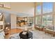 Open-concept living area with hardwood floors and large windows, seamlessly connecting to the kitchen and dining at 9743 Las Colinas Dr, Lone Tree, CO 80124