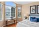 Well-lit main bedroom with hardwood floors, and a window seat offering views of the neighborhood at 9743 Las Colinas Dr, Lone Tree, CO 80124