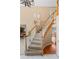 Elegant curved staircase featuring carpeted treads, a wooden handrail, and stylish chandelier overhead at 9743 Las Colinas Dr, Lone Tree, CO 80124