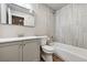 Bathroom featuring a vanity with a mirror, toilet, and a shower with a tub and tiled wall at 12919 W Burgundy Dr, Littleton, CO 80127