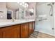 Bright bathroom featuring a walk-in shower, dual sinks, and a vanity at 12919 W Burgundy Dr, Littleton, CO 80127