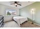 Cozy bedroom featuring a ceiling fan and a light-filled window view at 12919 W Burgundy Dr, Littleton, CO 80127
