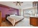 Spacious bedroom featuring a large bed, floating shelves, and neutral carpet at 12919 W Burgundy Dr, Littleton, CO 80127
