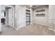 Versatile bonus room featuring custom built-ins and neutral carpet at 12919 W Burgundy Dr, Littleton, CO 80127