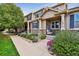 Inviting home with a well-maintained lawn, front porch, and stone detailing at 12919 W Burgundy Dr, Littleton, CO 80127