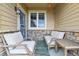 Charming front porch with seating, a colorful rug, and stone accents, perfect for relaxing outdoors at 12919 W Burgundy Dr, Littleton, CO 80127