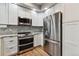 Well-equipped kitchen with stainless steel appliances, including a double oven and refrigerator at 12919 W Burgundy Dr, Littleton, CO 80127
