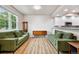 Bright living area with hardwood floors, vintage furniture, and natural light at 12919 W Burgundy Dr, Littleton, CO 80127