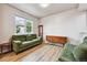 Cozy living room with a green sofa set, wooden furniture, and a bright window at 12919 W Burgundy Dr, Littleton, CO 80127